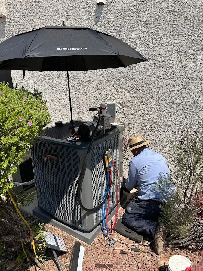 HVAC technician performing outdoor AC maintenance in Souderton