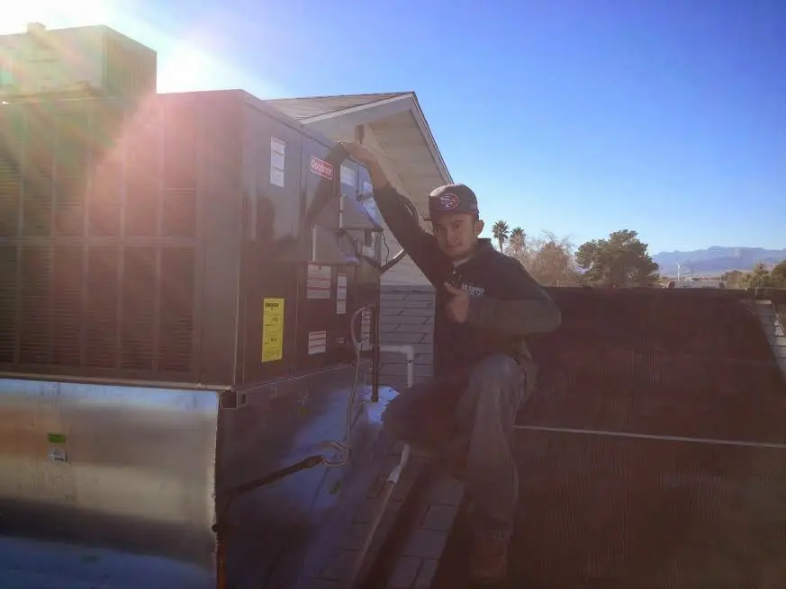 HVAC technician performing Boiler Repair on a rooftop unit in Souderton